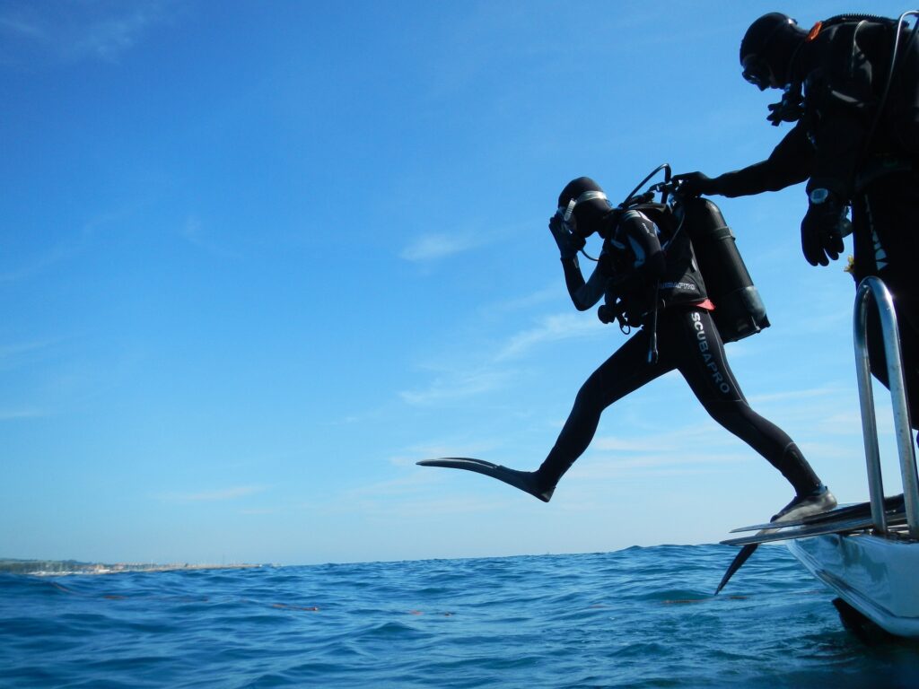 Scuba diving going into water photo